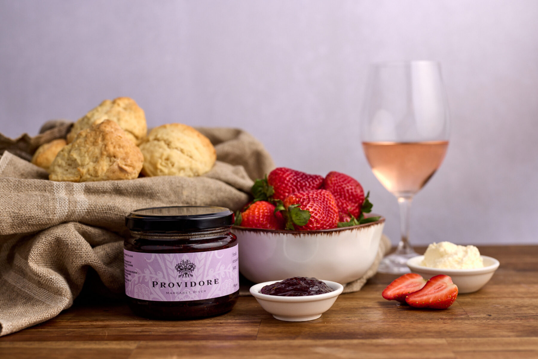 Providore jam with scones, strawberries and a glass of rosé