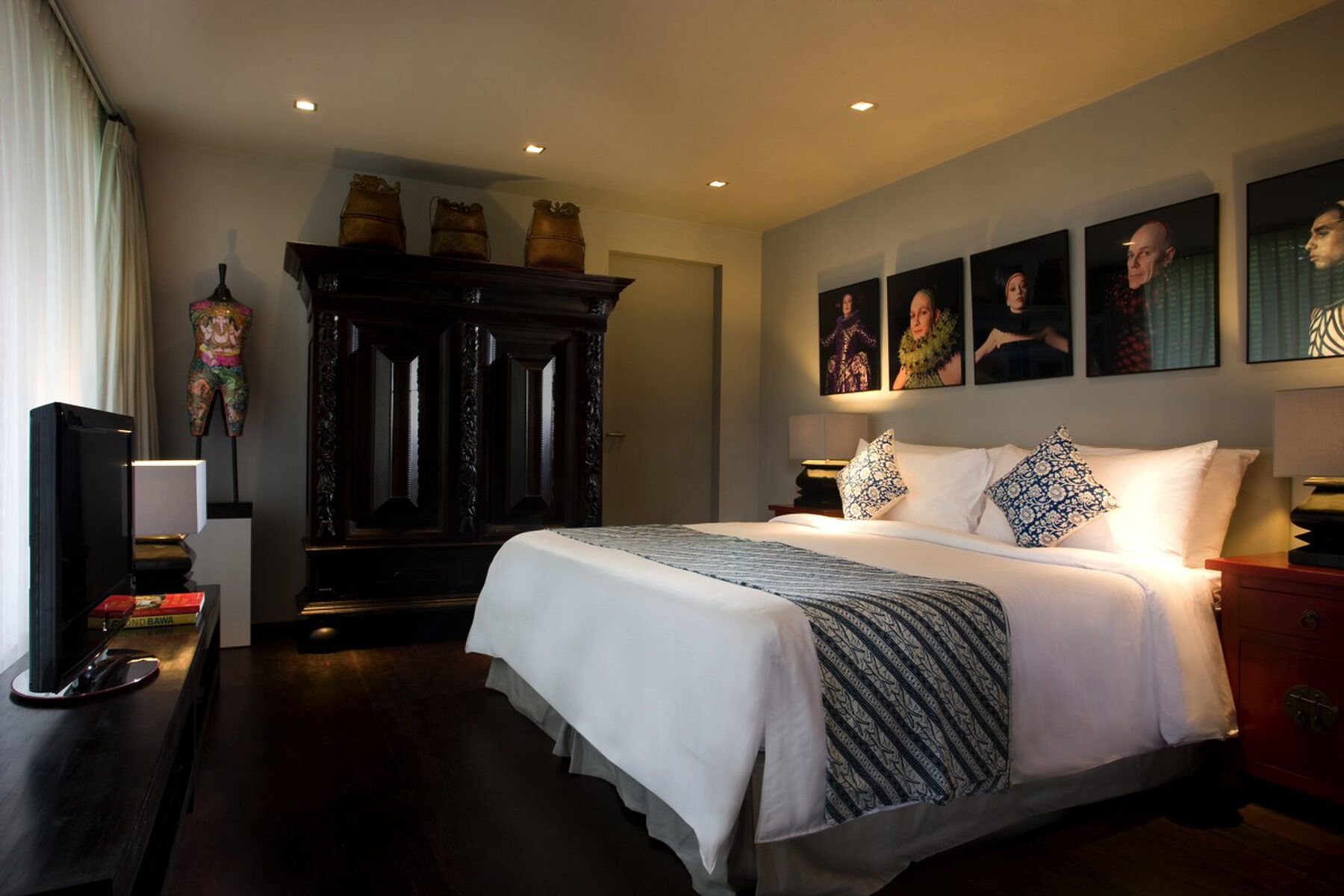 A four-poster bed with garden views at Villa Samuan