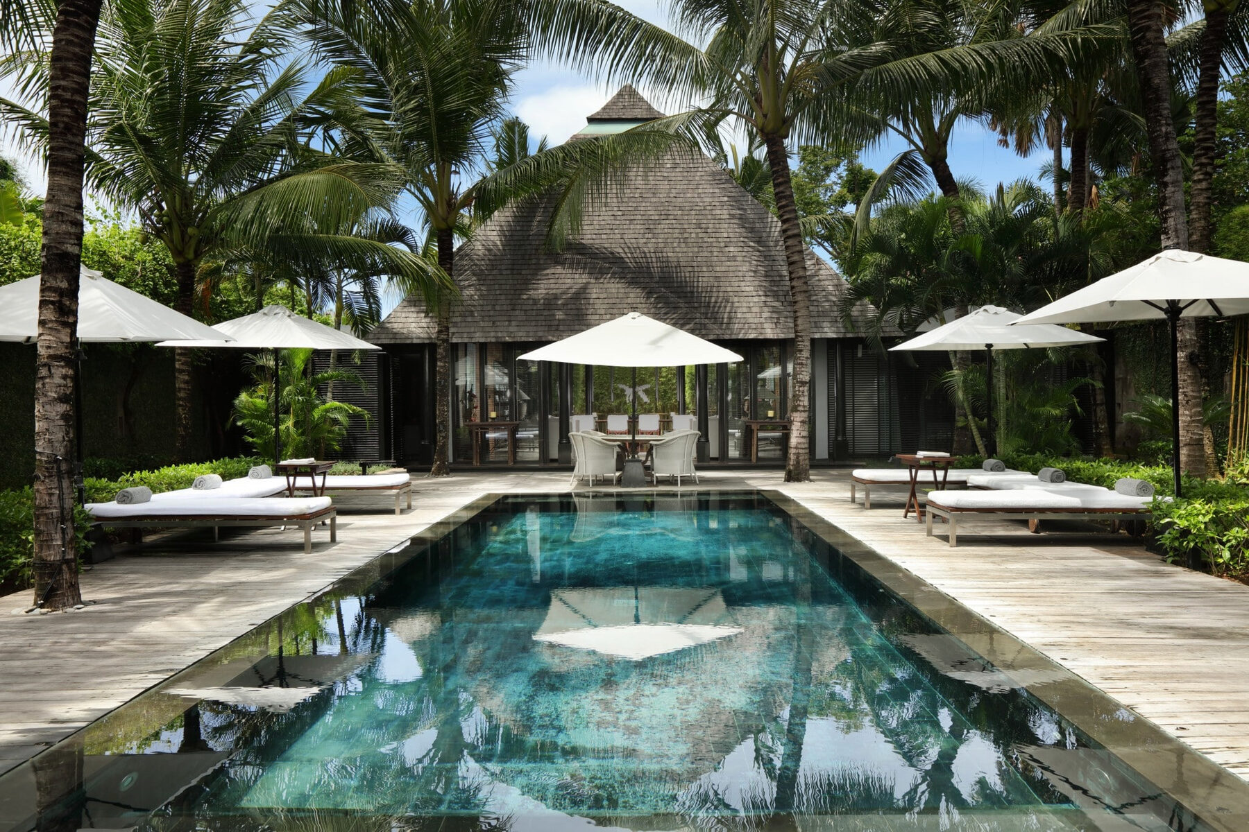 The main pool at Villa Samuan, framed by coconut palms